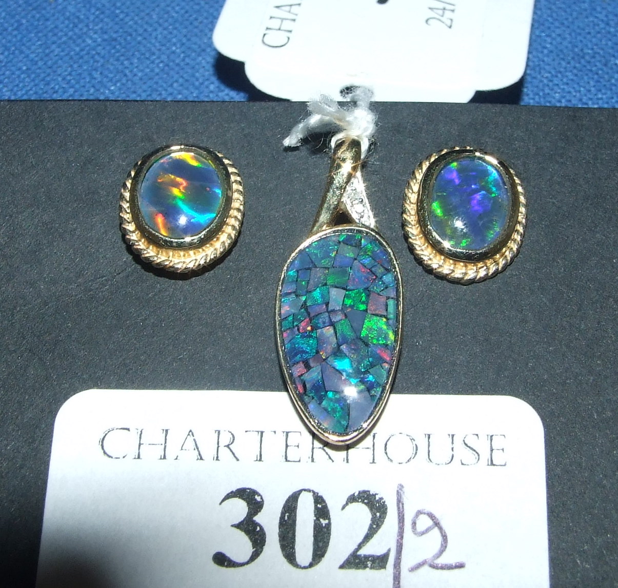 A 9ct yellow gold and black opal pendant, with a matching pair of stud earrings