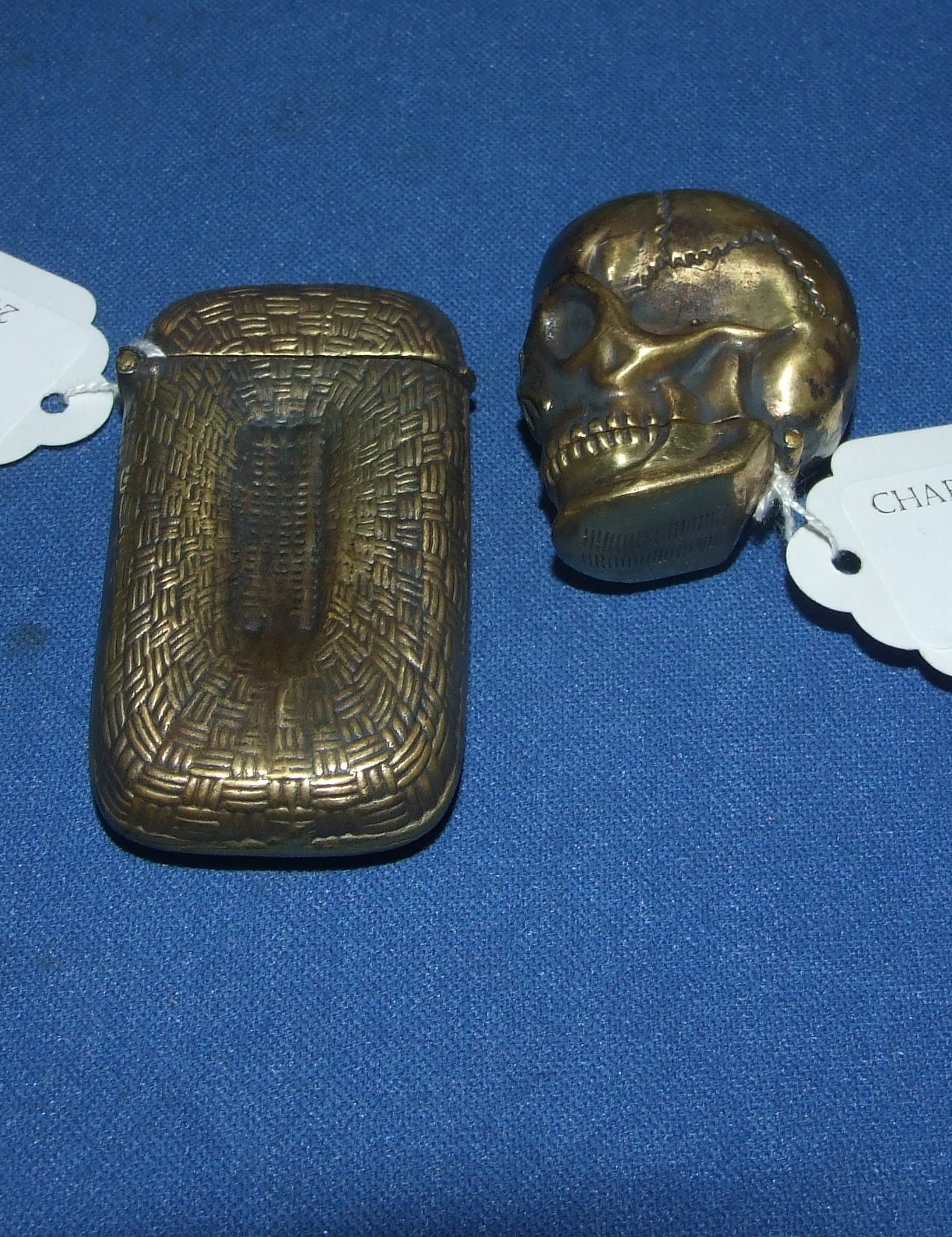 A brass skull vesta, and another vesta (2)