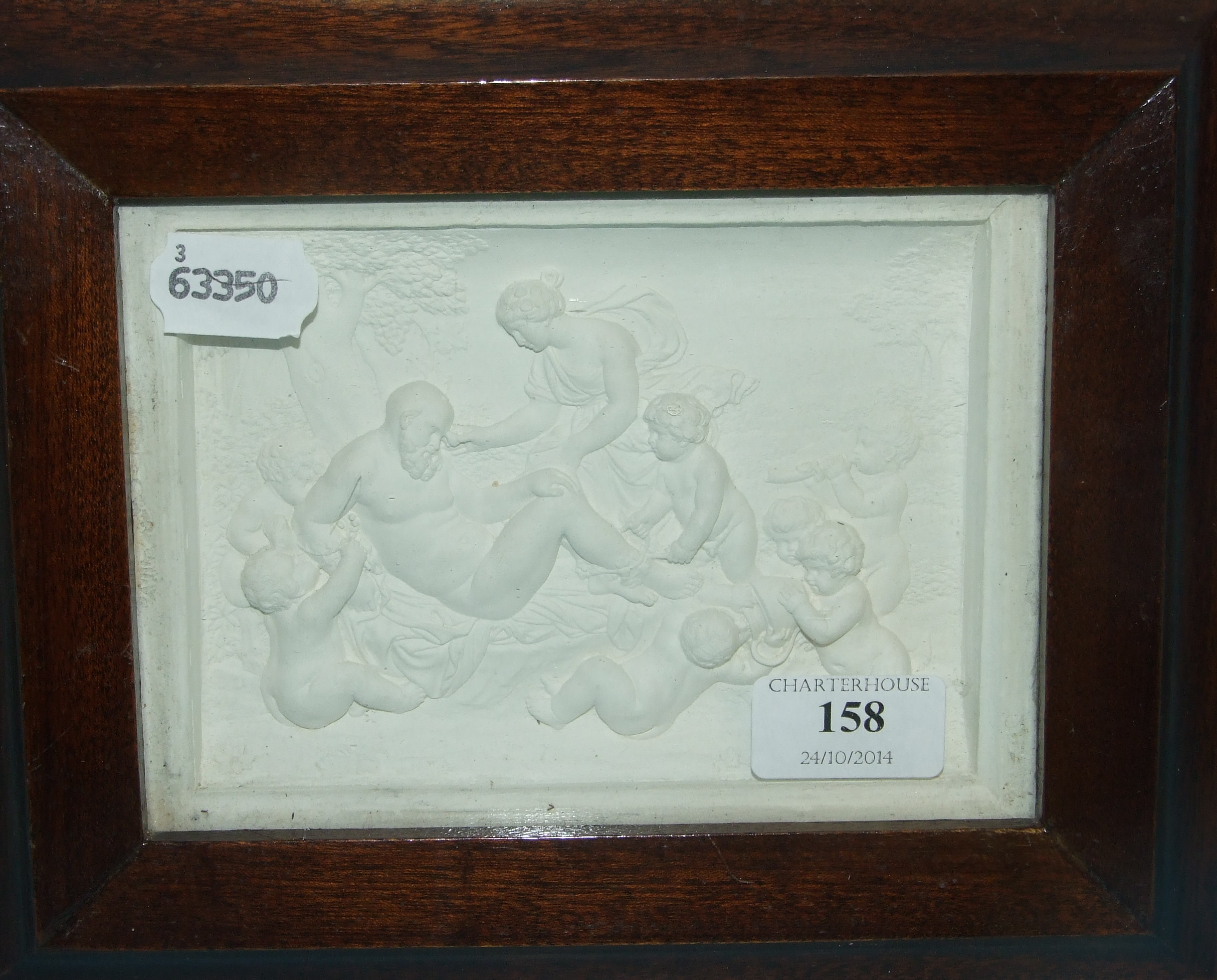 A cast plaster panel, after the antique, 12 x 17 cm, framed