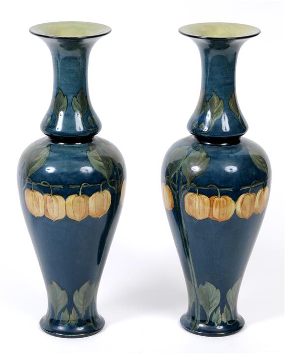 A pair of Art Nouveau Doulton Lambeth faience vases, decorated Chinese lanterns and foliage, the