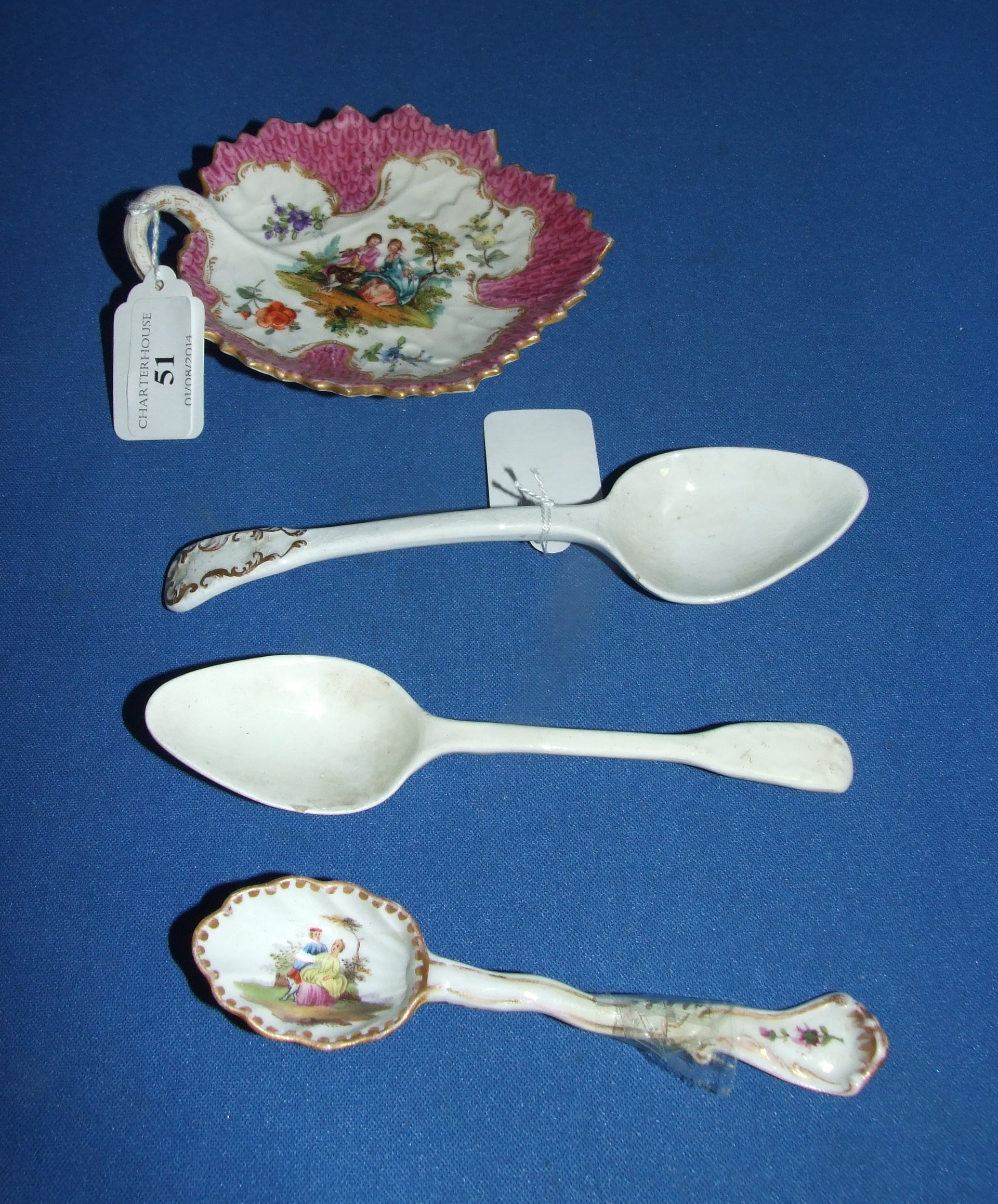 A Dresden porcelain plate, in the form of a leaf, 13.5 cm wide, and three porcelain spoons (a.f.) (