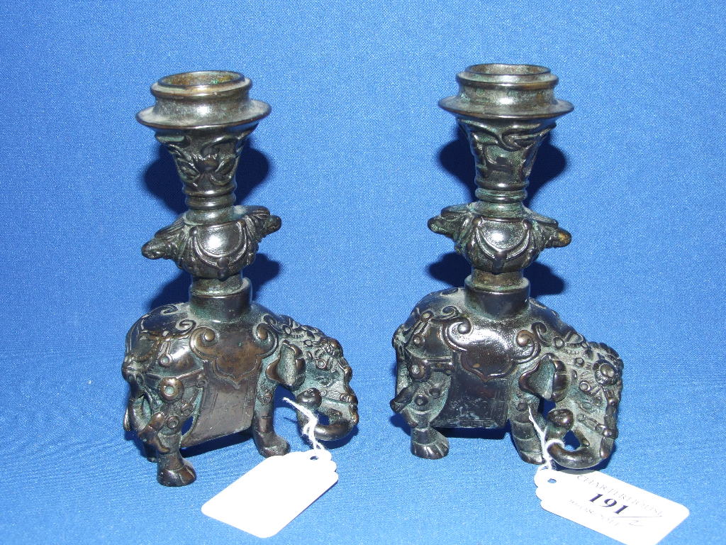 A pair of bronze candlesticks, in the form of elephants, 13 cm high