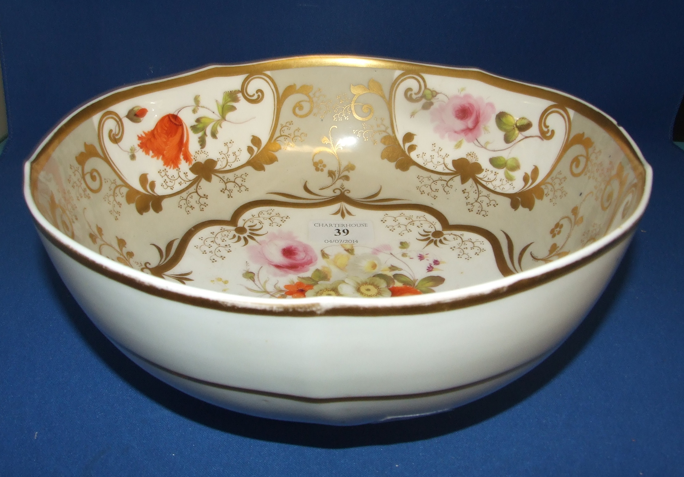 A 19th century English porcelain bowl, decorated flowers and foliage (a.f.) 27 cm diameter