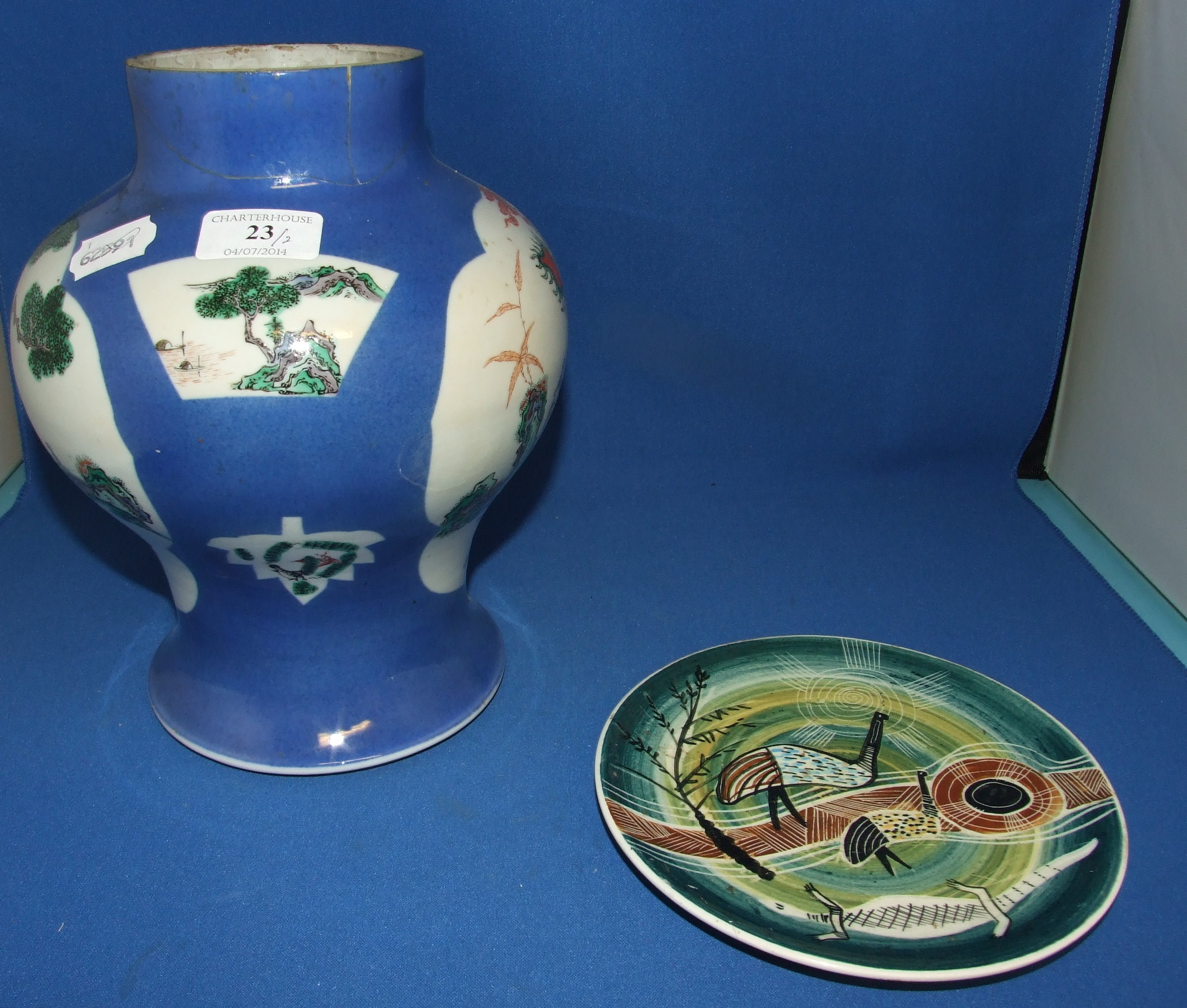 A Chinese porcelain vase, decorated panels of figures and landscape, on a powder blue ground, 25