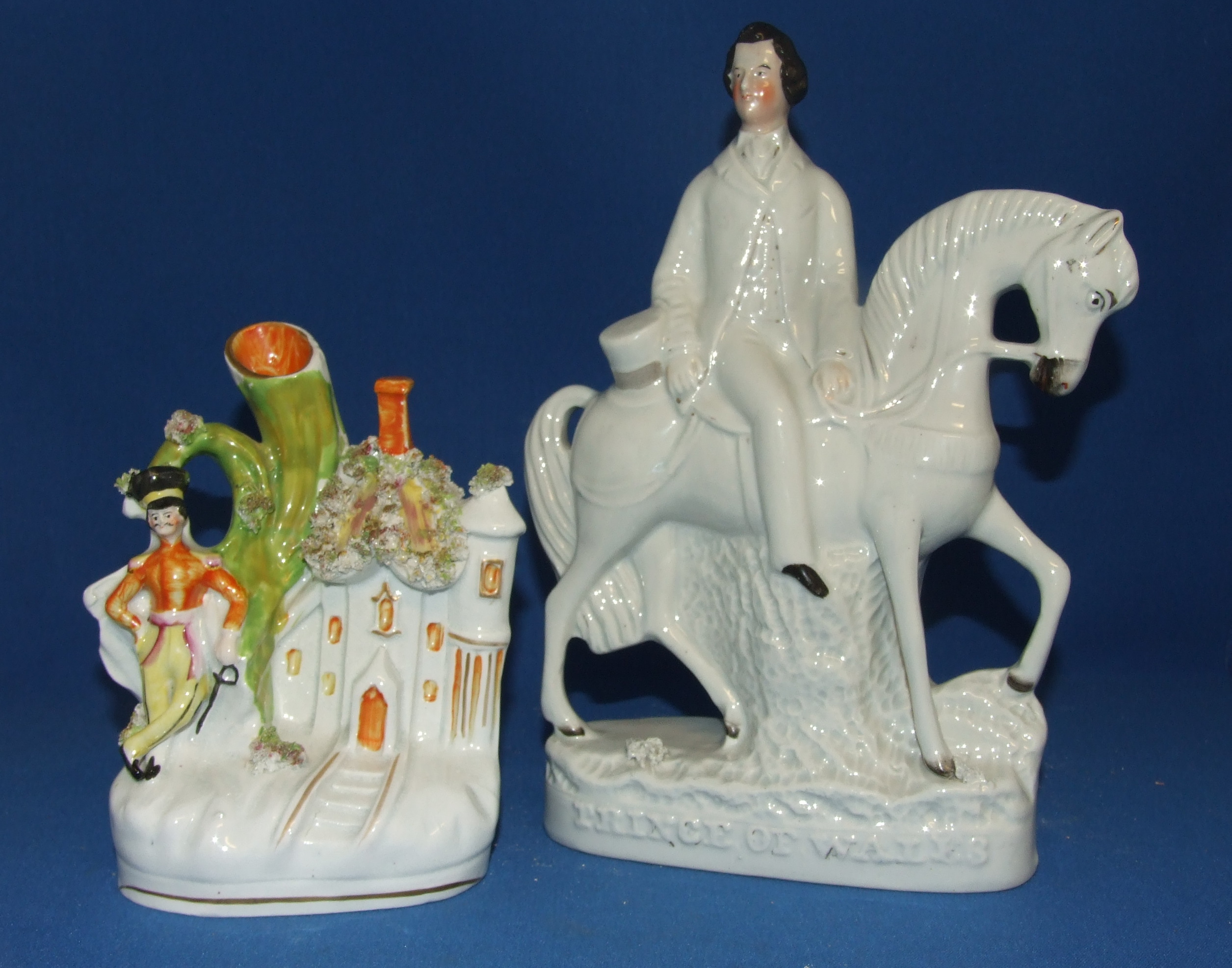 A Staffordshire pottery figure, Prince of Wales, 27 cm high, and a similar spill vase (a.f.) (2)