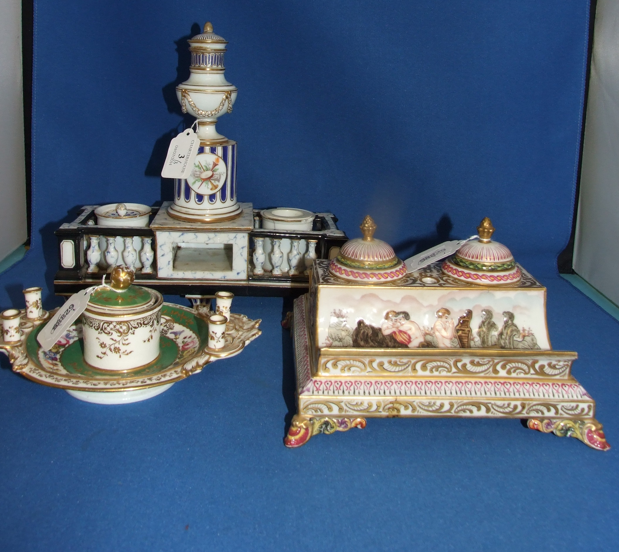 A Continental porcelain desk stand, decorated classical scenes, 19.5 cm wide, and two others similar