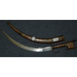 An Arabian Nimcha dagger with an inlaid handle and scabbard, 62 cm