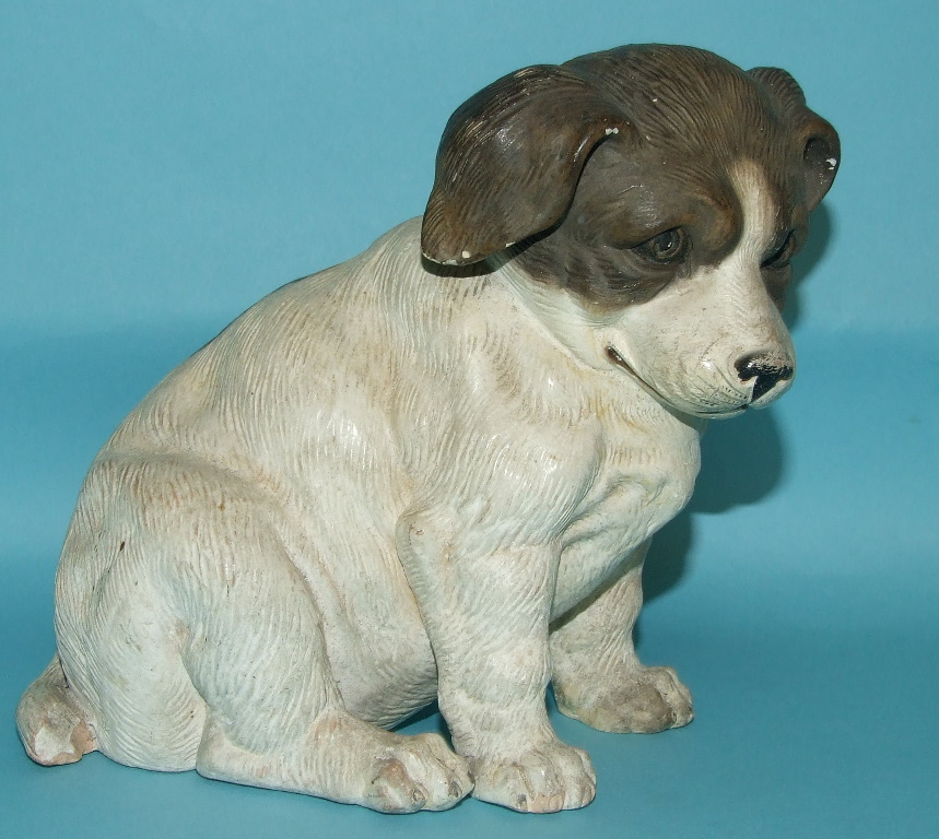 A late 19th century terracotta figure, of a puppy (slightly chipped), 15 cm high