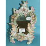 A Sitzendorf style porcelain strut mirror, applied putto, putti, flowers and foliage, 28.5 cm high