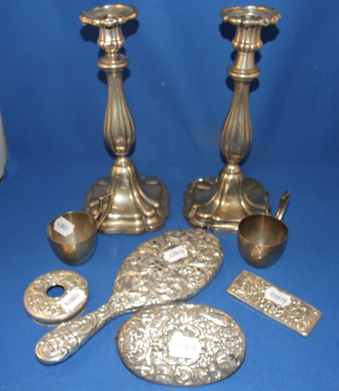 A pair of Continental silver coloured metal candlesticks, 29 cm high, two mugs, and a silver part