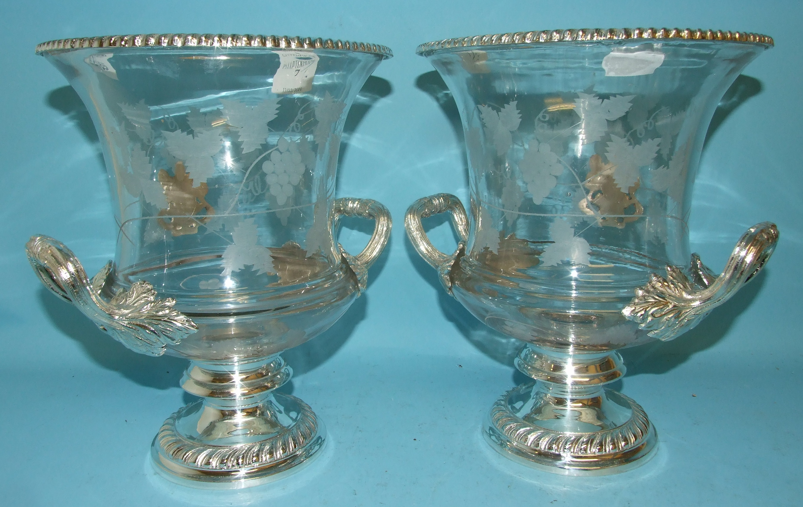 A pair of glass and silver plated wine coolers, 28 cm high