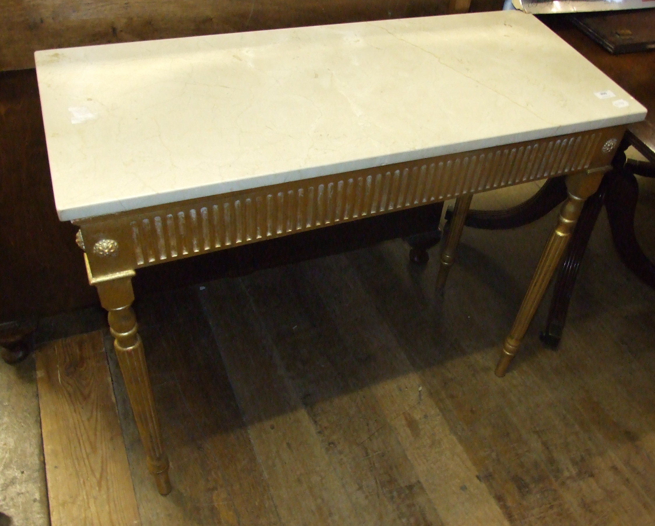 A gilt side table, with a marble top, 91 cm wide