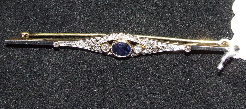 A yellow coloured metal, sapphire and diamond brooch