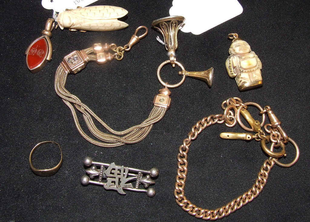 A carved bone brooch, in the form of a lotus, a yellow coloured metal signet ring, and other items