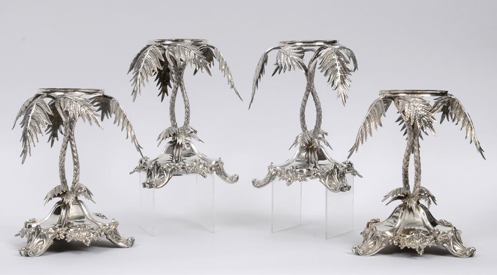 A set of four Victorian silver plated centrepieces, on stylised palm tree supports, crested, 24.5 cm