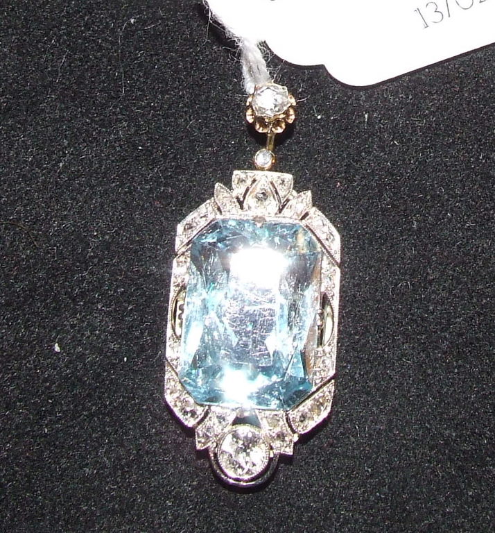 A yellow coloured metal, aquamarine and diamond pendant