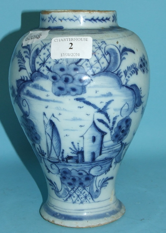 An 18th century Dutch Delft vase, decorated a boat, a dwelling and foliage, 20.5 cm high Condition