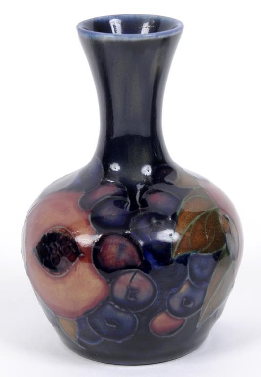 A Moorcroft pottery Pomegranate pattern vase, the base impressed Moorcroft England, 9 cm high  See
