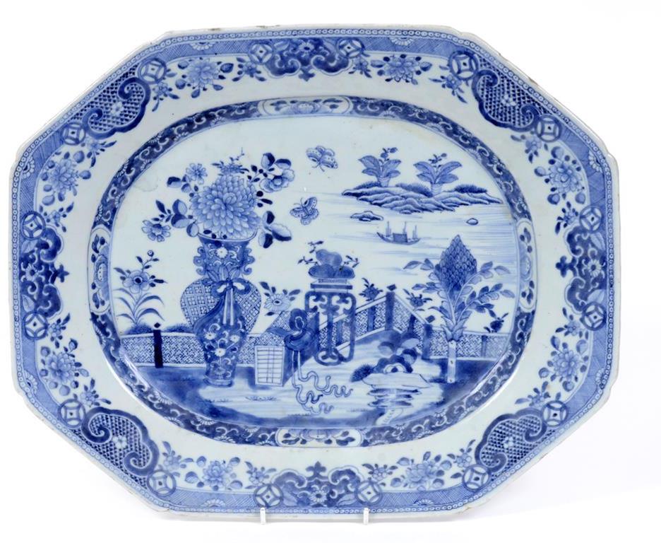 A Chinese porcelain meat plate, decorated in underglaze blue with a vase of flowers, butterflies and
