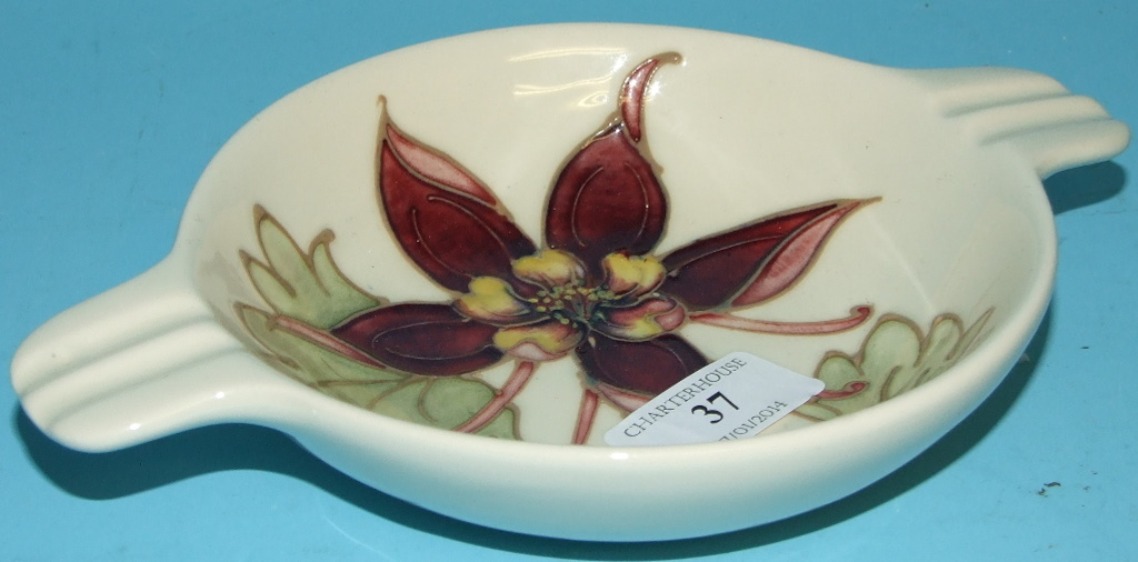 A Moorcroft pottery Columbine pattern ashtray, 21 cm wide