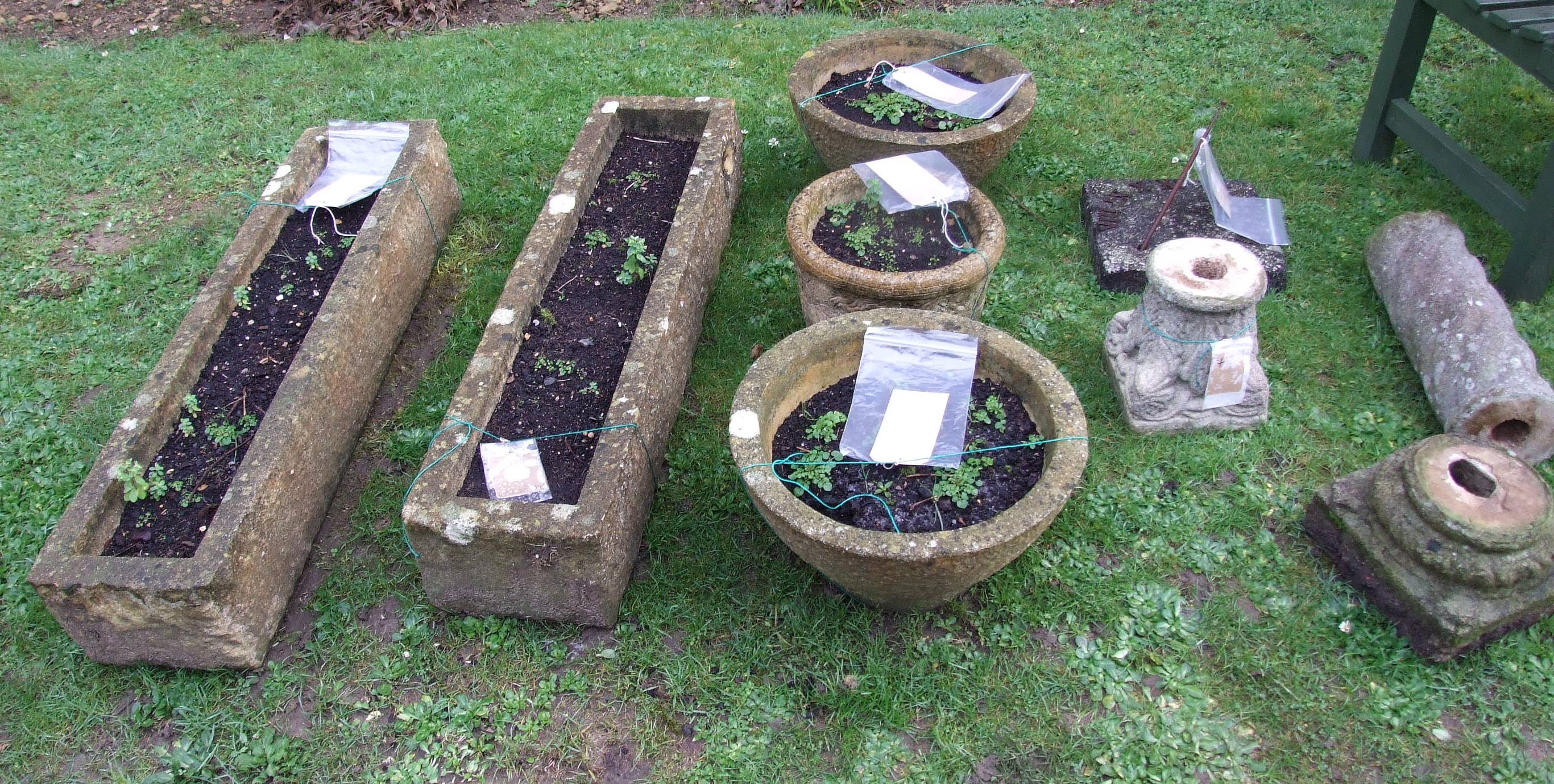 A pair of stone troughs, 102 cm wide, three other garden pots and a sundial (qty)