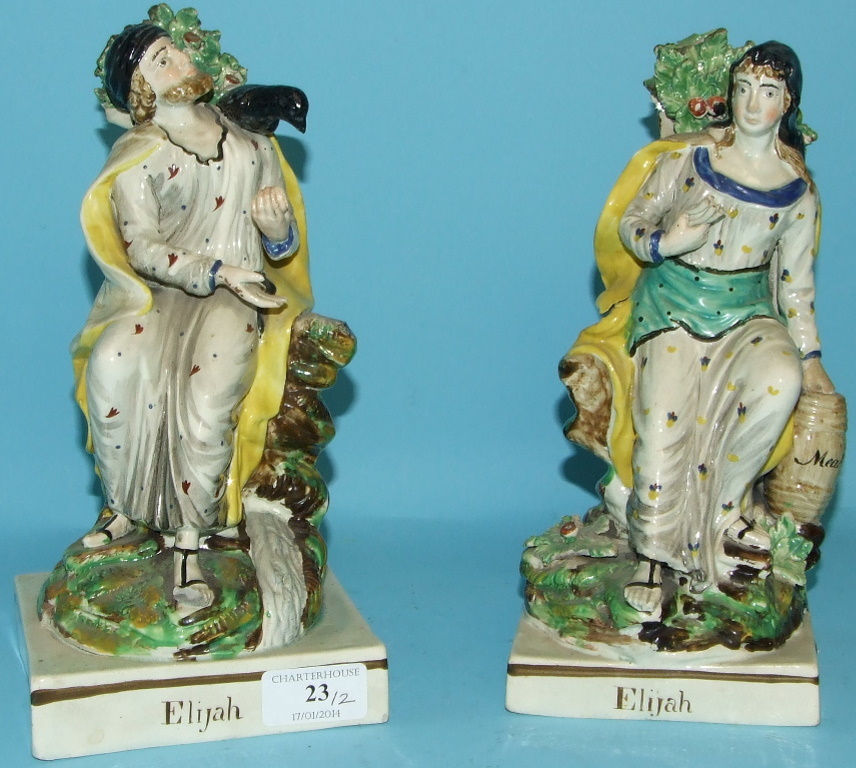 A pair of Staffordshire pottery figures, Elijah and his widow, the largest 25.5 cm high (a.f.) (2)