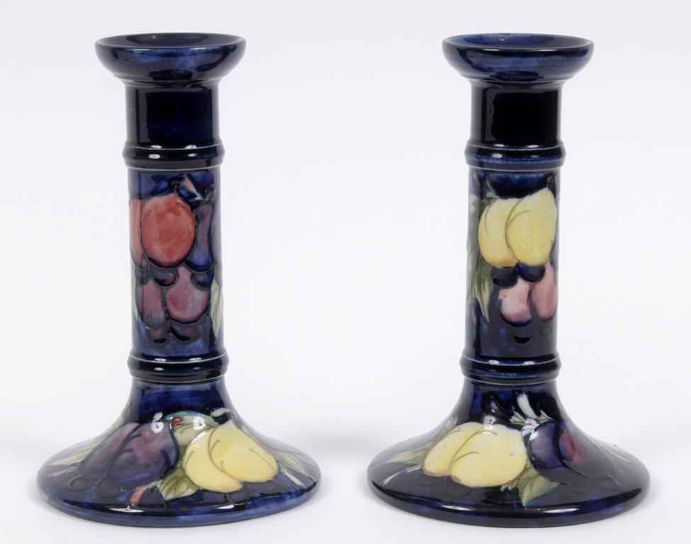 A pair of Moorcroft pottery Wisteria pattern candlesticks, each base impressed Moorcroft Made In