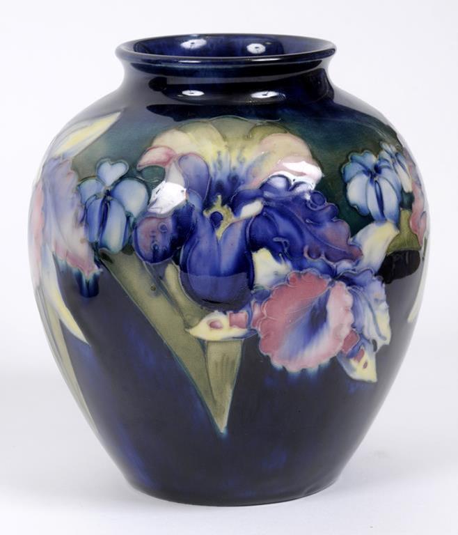 A Moorcroft pottery Orchid pattern vase, on a green ground, the base impressed Moorcroft Made In