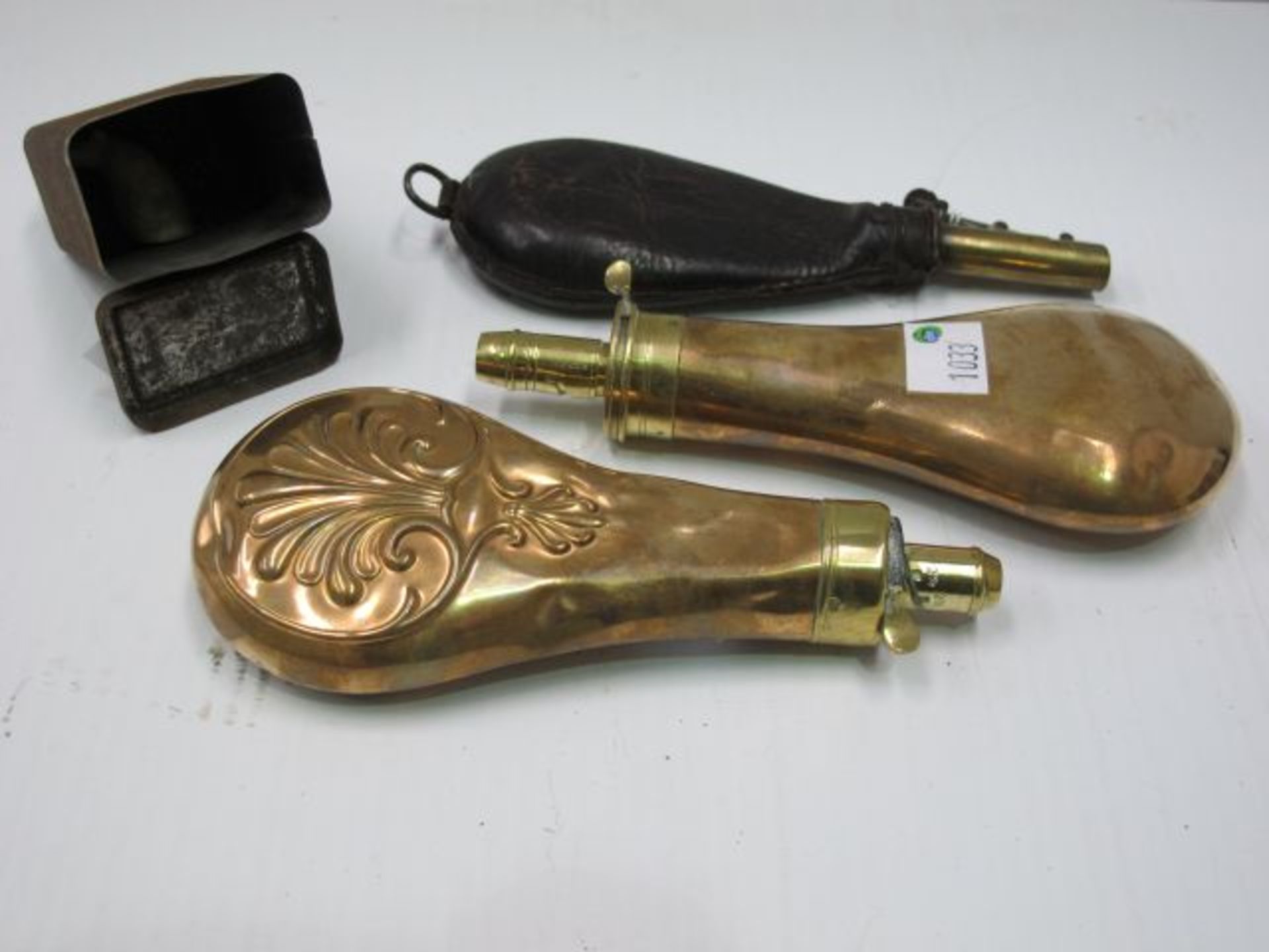A Leather and Brass Shot dispenser (with Shot) together with a tin of Shot. A Brass and Copper