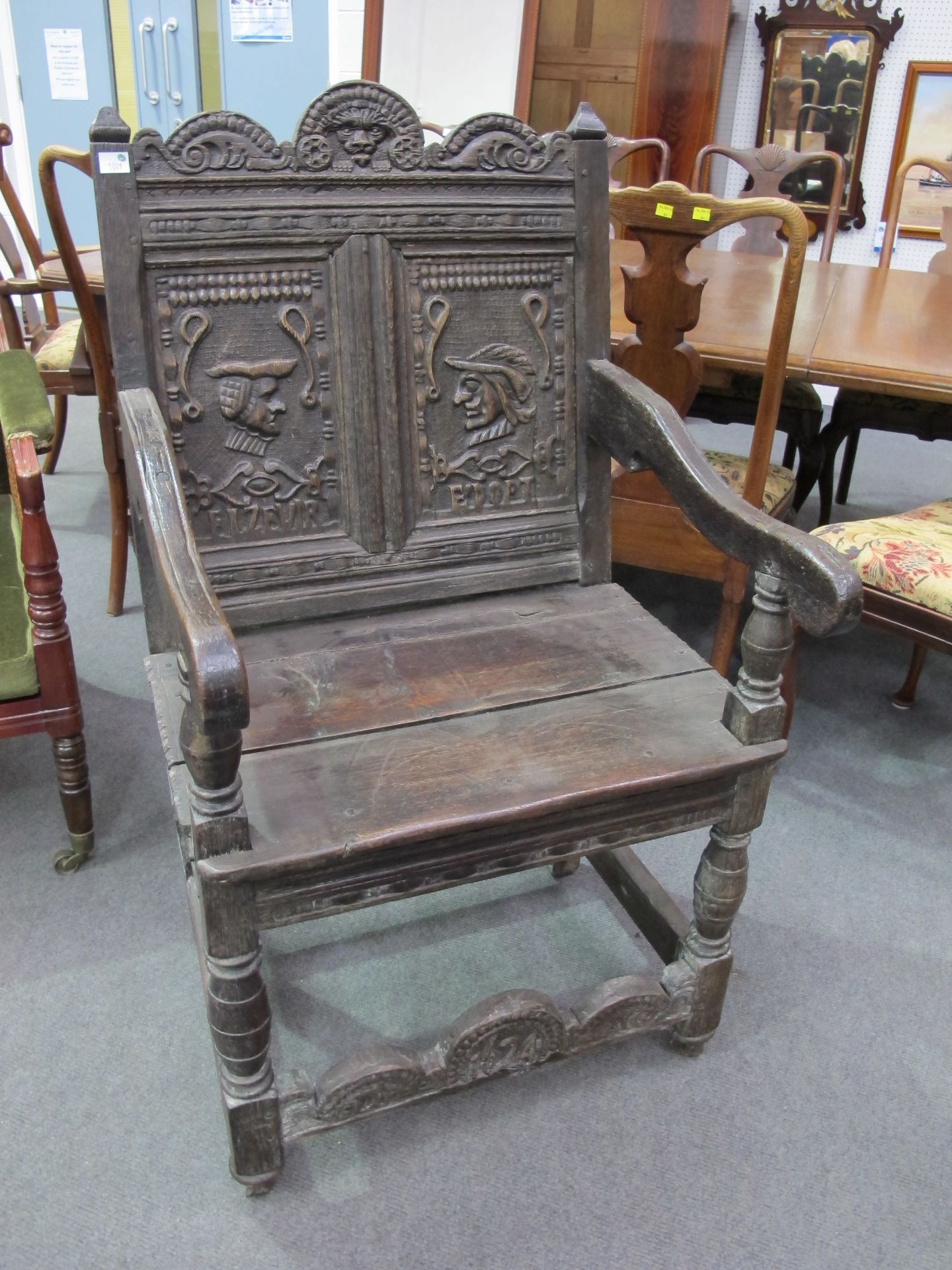 A 17th Century Style Oak Wainscot Chair with carved panels to the back and top rail; plain seat,