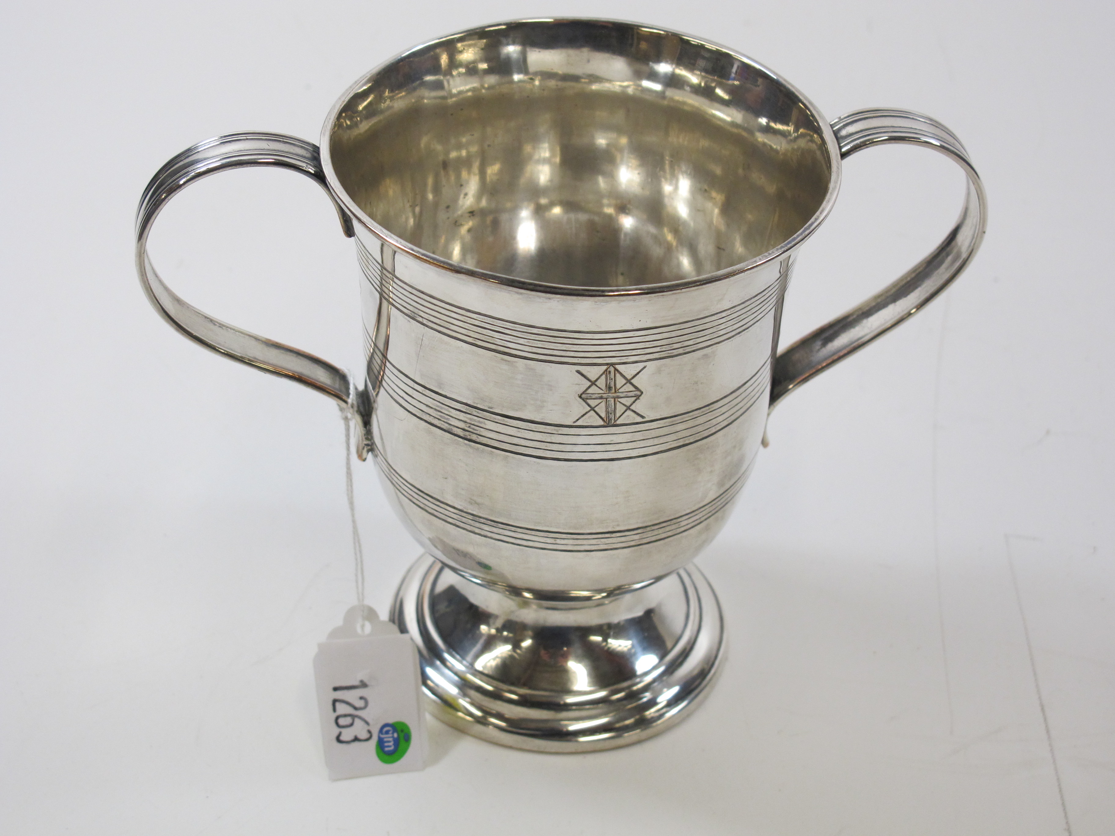 "Click here to bid.  An antique two-handled loving cup style mug (est. £20 - £40)"