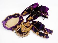 A pair of Eastern-style velvet flat boots with button and laced fastenings, a matching beret and