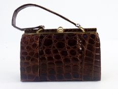 A Riviera brown crocodile 'Kelly' style bag with suede lining, fixed frame and brass coloured