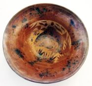 Asian terracotta bowl with incised decoration of fish and foliage, in a mottled iron-red and black