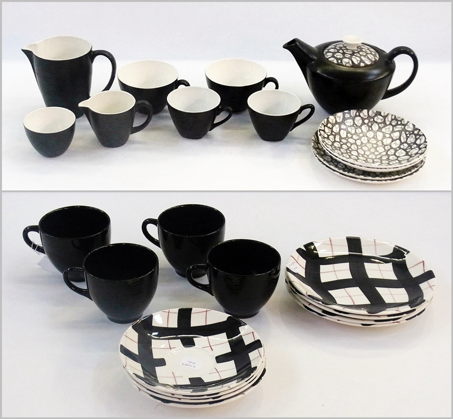 A Empress pottery 1950's-style set of four black glazed teacups with matching trellis-patterned