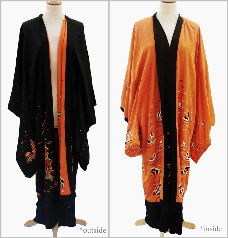 A Japanese embroidered silk kimono, reversible from orange to black, embroidered with pagoda,