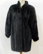 Black mink 3/4 length coat, labelled "Saga Mink" and "100% Bemberg"