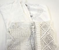 White circular drawn threadwork tablecloth with scalloped borders, a quantity of crocheted net and