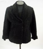 A black Persian lamb three-quarter length coat