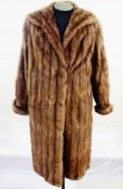 A full-length vintage musquash coat