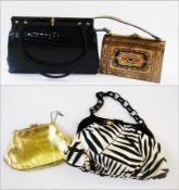 A black fixed frame crocodile handbag with two carrying straps, a gold kid evening bag, an eastern-