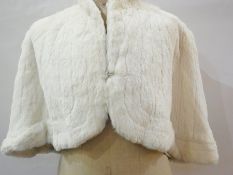 A vintage white fur shoulder cape (possibly coney) with a pair of white kid gloves