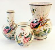 A set of three Portuguese graduated and variously shaped pottery vases with exotic bird and