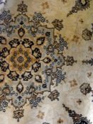Wool rug of ivory ground with central pink medallion, and light-blue and pink borders, and a