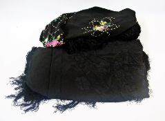 A large black Chinese silk embroidered shawl together with another small black embroidered shawl (2)