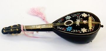 A mandolin musical box inlaid with white coloured metal flowers, birds