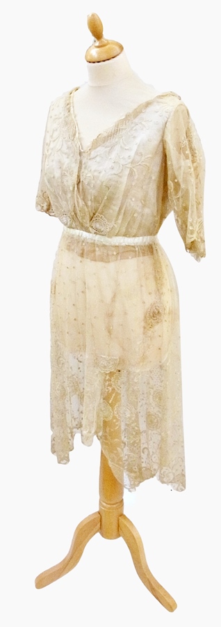 A 1920's lace dress, the skirt shorter in front, lacking lining to skirt (af), a silk and lace