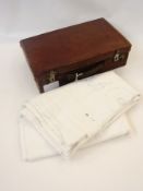 A brown leather attache case together with a damask tablecloth (2)