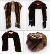 A grey mink stole trimmed with tails, a squirrel stole labelled "Creamers, Birmingham", a mink stole