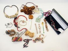 A quantity of costume jewellery to include bangles, lady's watches, beaded necklaces, hat pins (1